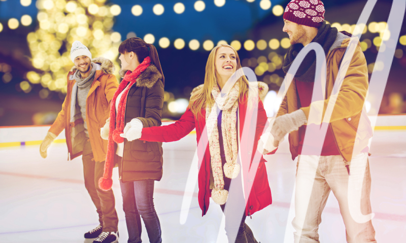 two couples dressed warmly are ice skating together
